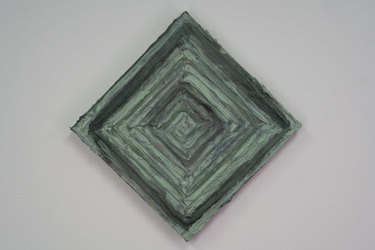 A green and mint textured painting that is in the shape of a diamond, front view